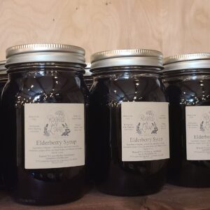 Row of pint jars of elderberry syrup